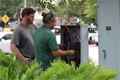 Workers looking at wiring at park