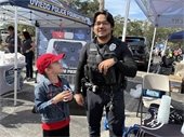 Officer Chow with child holding trading card